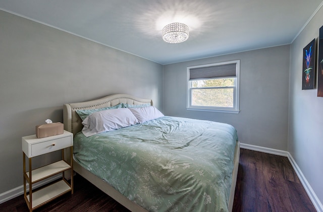 bedroom with baseboards and wood finished floors