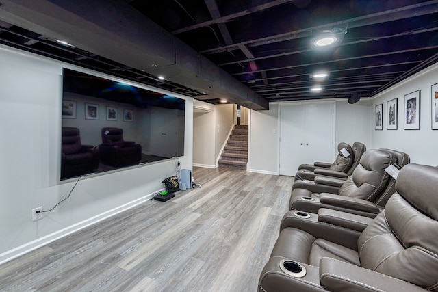 home theater featuring baseboards and wood finished floors