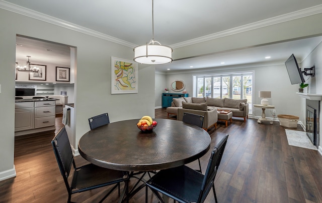 dining space with a fireplace with flush hearth, recessed lighting, dark wood-type flooring, and crown molding