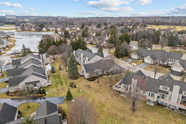 bird's eye view featuring a water view and a residential view