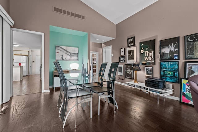 dining space with visible vents, baseboards, and wood finished floors