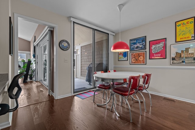 dining space featuring visible vents, baseboards, and wood finished floors