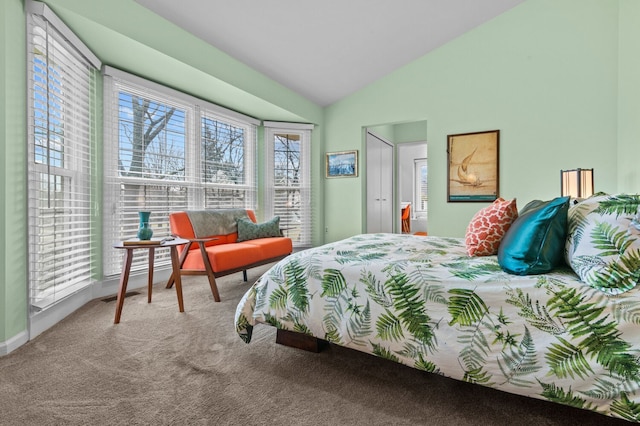 carpeted bedroom featuring lofted ceiling and visible vents