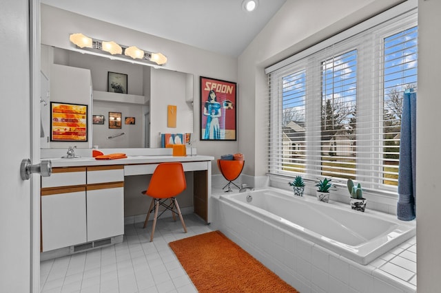 full bathroom featuring lofted ceiling, a garden tub, vanity, and tile patterned floors