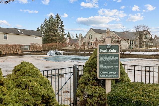 surrounding community with a residential view and fence