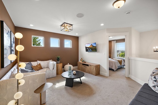 carpeted living room with baseboards, a chandelier, and recessed lighting