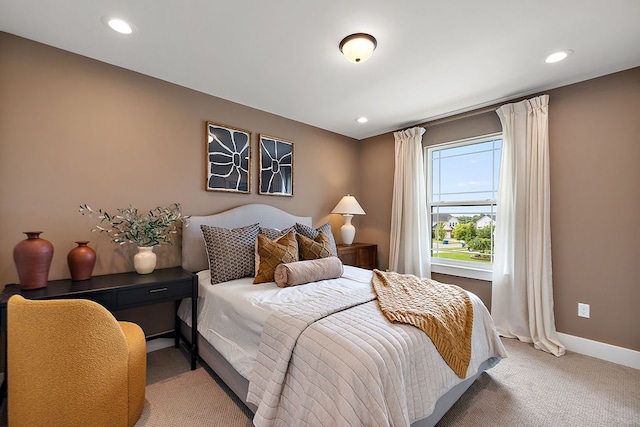 bedroom featuring light carpet, baseboards, and recessed lighting