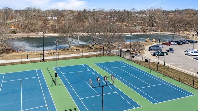 view of tennis court featuring fence