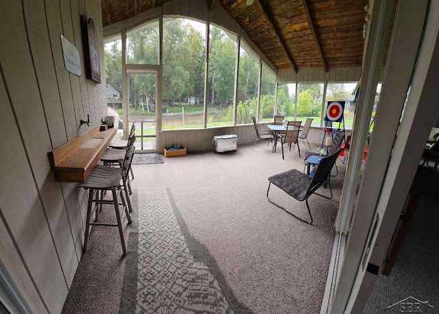 sunroom featuring lofted ceiling with beams and wood ceiling