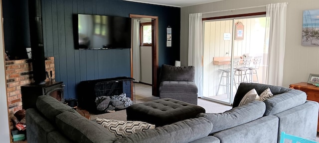 living room featuring carpet flooring and a wood stove