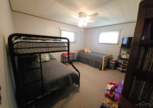 bedroom featuring multiple windows, carpet flooring, and a ceiling fan