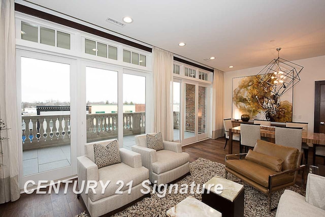 living room featuring an inviting chandelier, visible vents, dark wood finished floors, and recessed lighting