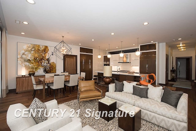 living area with dark wood-type flooring and recessed lighting