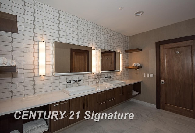 full bathroom featuring double vanity, tasteful backsplash, and a sink