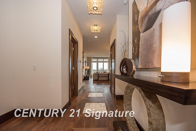 hall with wood finished floors and baseboards