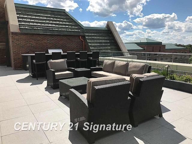 view of patio featuring a balcony and an outdoor hangout area