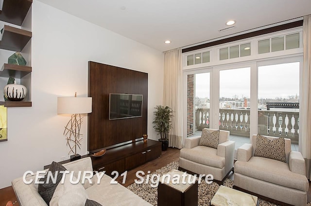 living room with visible vents, wood finished floors, and recessed lighting