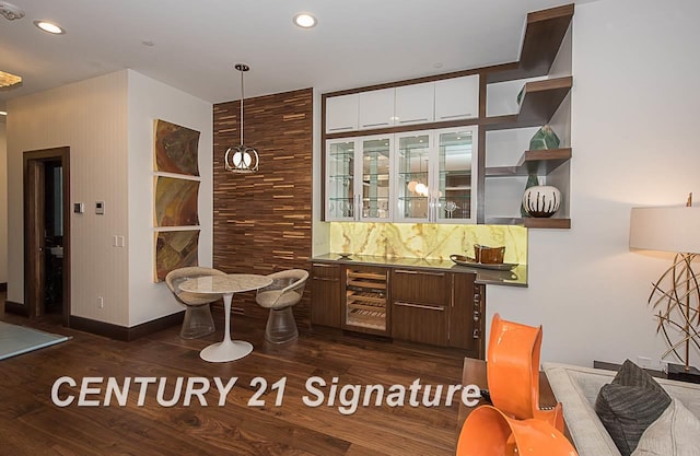 bar with wine cooler, recessed lighting, dark wood-style flooring, wet bar, and decorative light fixtures