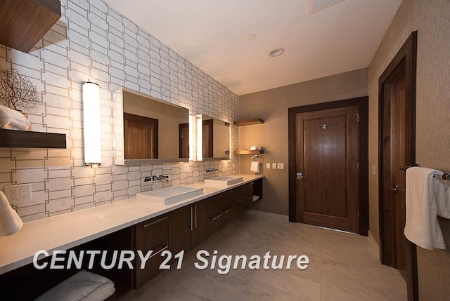 bathroom featuring double vanity, decorative backsplash, and a sink