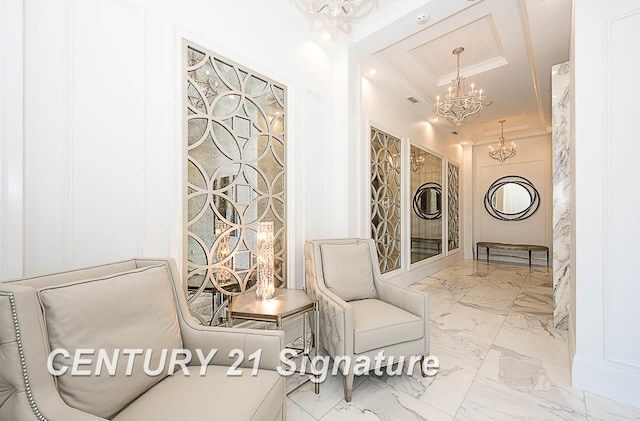 living area with a chandelier, marble finish floor, and ornamental molding