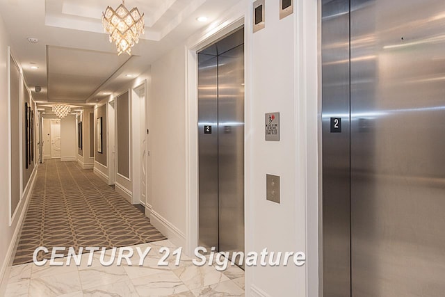 corridor with recessed lighting, elevator, a tray ceiling, and baseboards