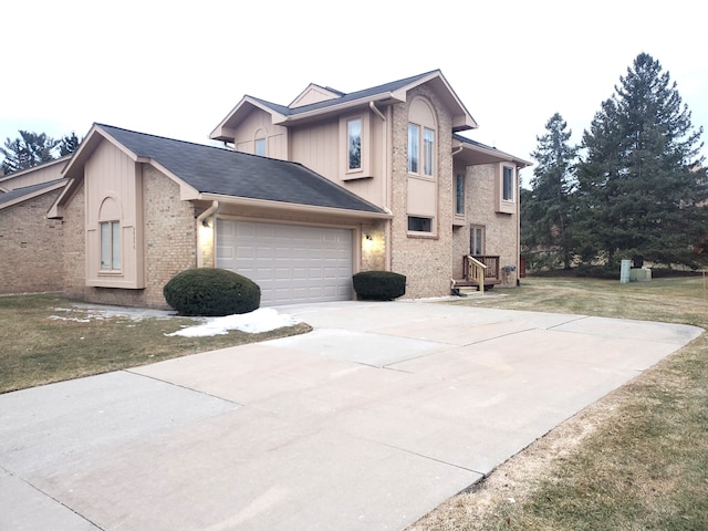 view of side of home with brick siding, a lawn, an attached garage, and driveway