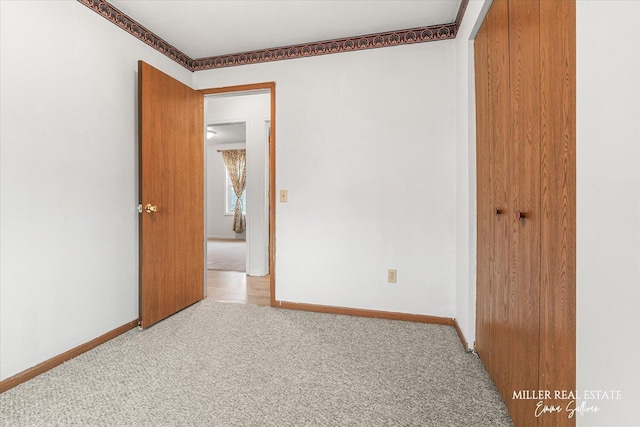 carpeted spare room with baseboards