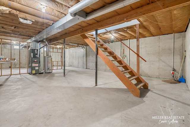 unfinished below grade area with gas water heater, heating unit, and stairs