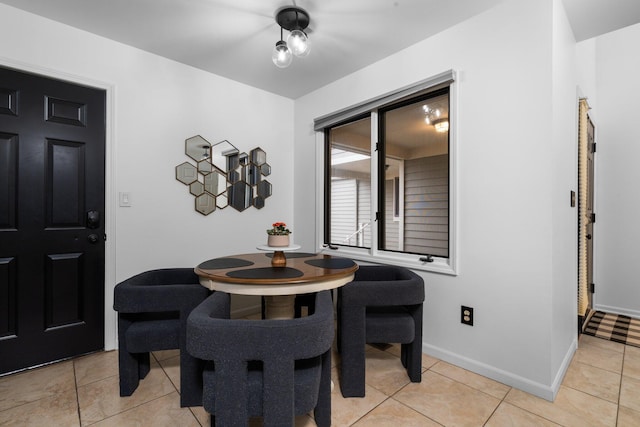 dining area with light tile patterned floors and baseboards
