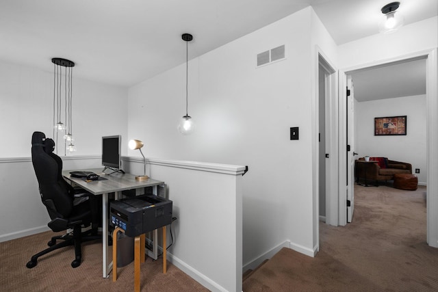 carpeted office space with visible vents and baseboards