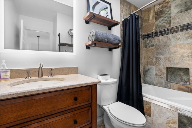 bathroom with a tiled fireplace, toilet, vanity, and tiled shower / bath combo