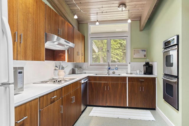 6863 Crystal Dr, Beulah, MI 49617 - kitchen with appliances with stainless steel finishes, under cabinet range hood, wooden ceiling, light countertops, and brown cabinets