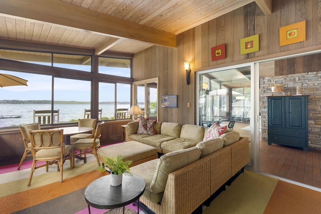 6863 Crystal Dr, Beulah, MI 49617 - living area with plenty of natural light, wooden walls, a water view, and a wooden ceiling with exposed beams