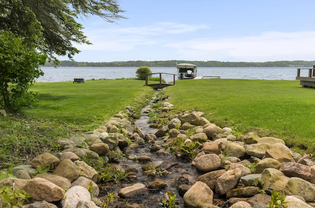 6863 Crystal Dr, Beulah, MI 49617 - view of grassy yard with a water view and a dock
