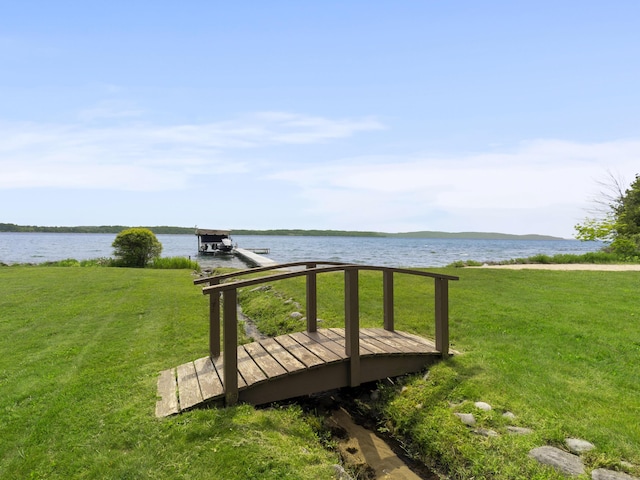 6863 Crystal Dr, Beulah, MI 49617 - deck with a water view, a lawn, and a dock
