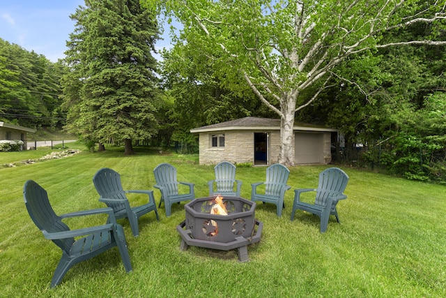 6863 Crystal Dr, Beulah, MI 49617 - view of green lawn with an outdoor fire pit and an outbuilding