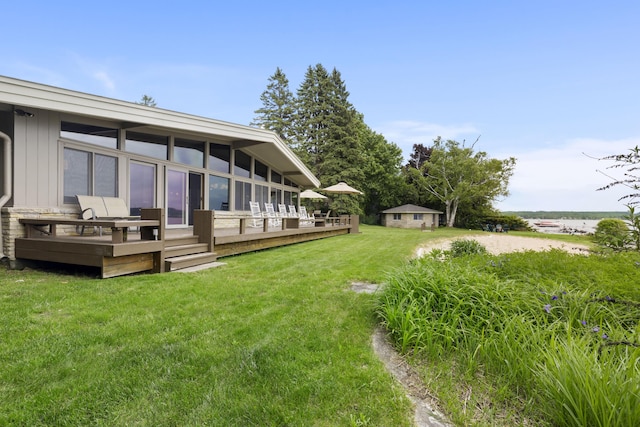 6863 Crystal Dr, Beulah, MI 49617 - view of grassy yard with a deck