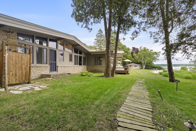 6863 Crystal Dr, Beulah, MI 49617 - view of green lawn featuring a water view