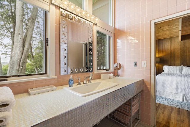 6863 Crystal Dr, Beulah, MI 49617 - bathroom with vanity, ensuite bath, and wood finished floors