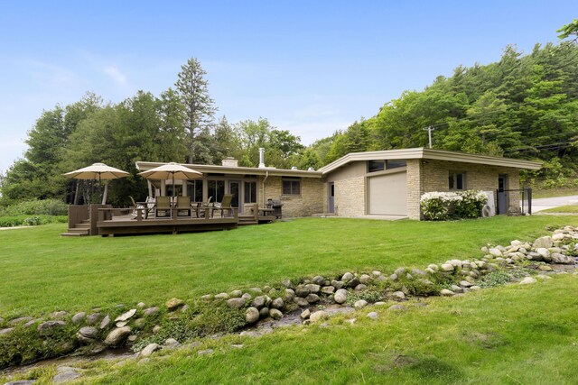 6863 Crystal Dr, Beulah, MI 49617 - back of house with a deck, a lawn, a chimney, a garage, and brick siding
