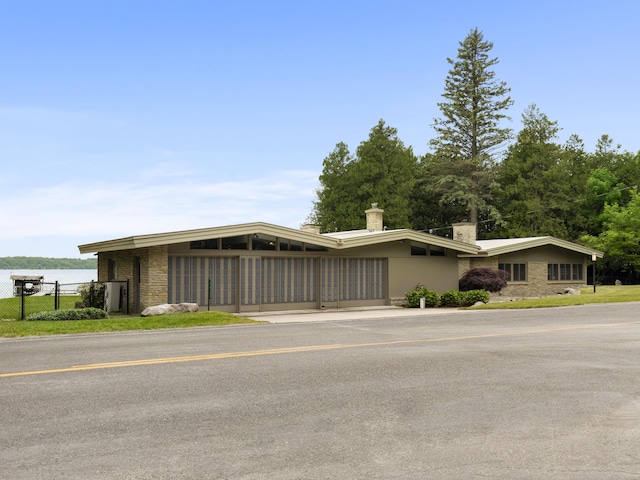 6863 Crystal Dr, Beulah, MI 49617 - view of front facade featuring a chimney