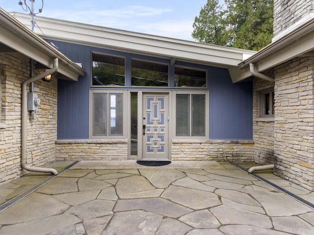 6863 Crystal Dr, Beulah, MI 49617 - view of exterior entry with stone siding and board and batten siding