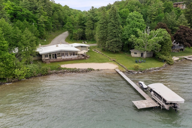 6863 Crystal Dr, Beulah, MI 49617 - dock area with a water view, a lawn, and a wooded view