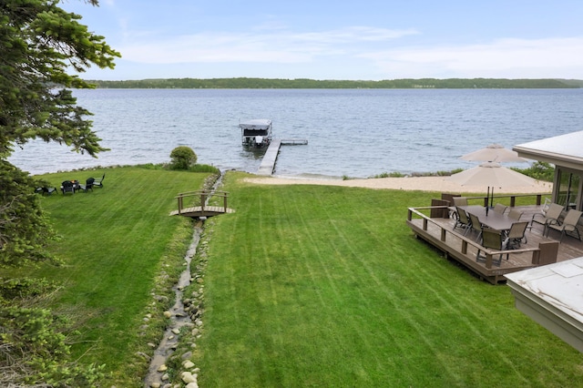 6863 Crystal Dr, Beulah, MI 49617 - view of green lawn with a water view and a boat dock