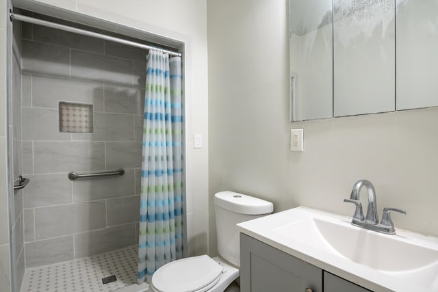 full bath featuring toilet, a shower stall, and vanity