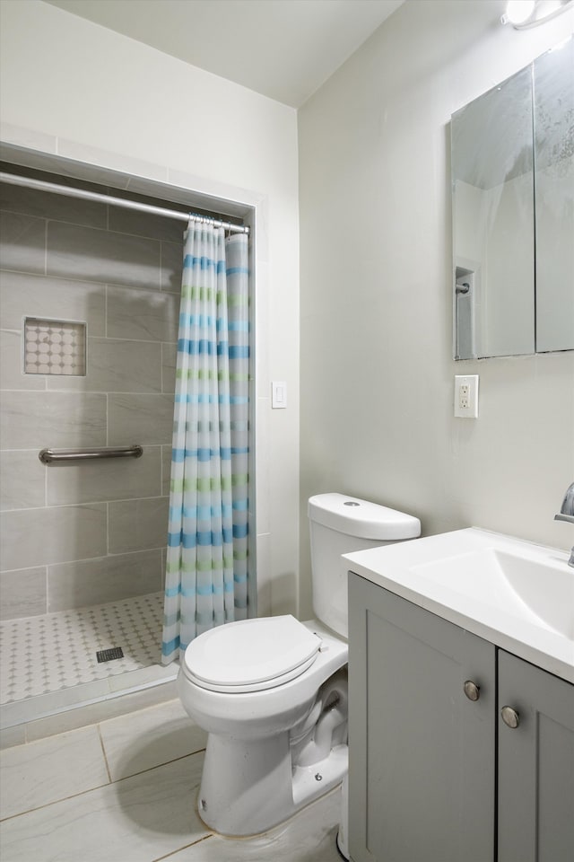 full bath featuring a shower stall, vanity, and toilet