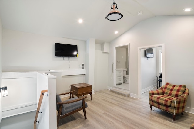 living area with light wood finished floors, recessed lighting, vaulted ceiling, an upstairs landing, and baseboards