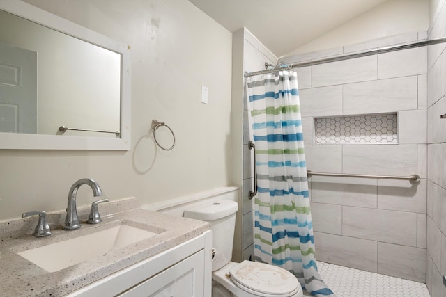 full bath with vaulted ceiling, vanity, a tile shower, and toilet