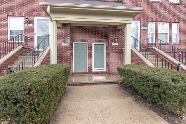 doorway to property featuring brick siding