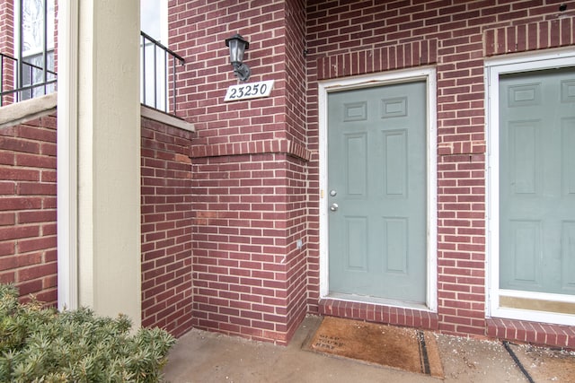 property entrance with brick siding